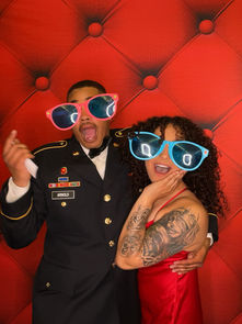 Guests posing in colorful photo booth props